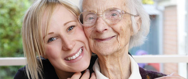 Stock photo of older woman embracing younger woman