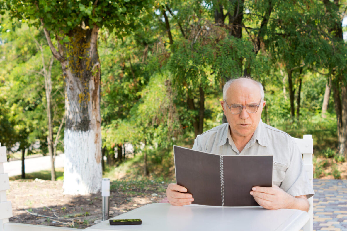 Mature,Caucasian,Man,Reading,The,Menu,At,A,Restaurant,,Keeping