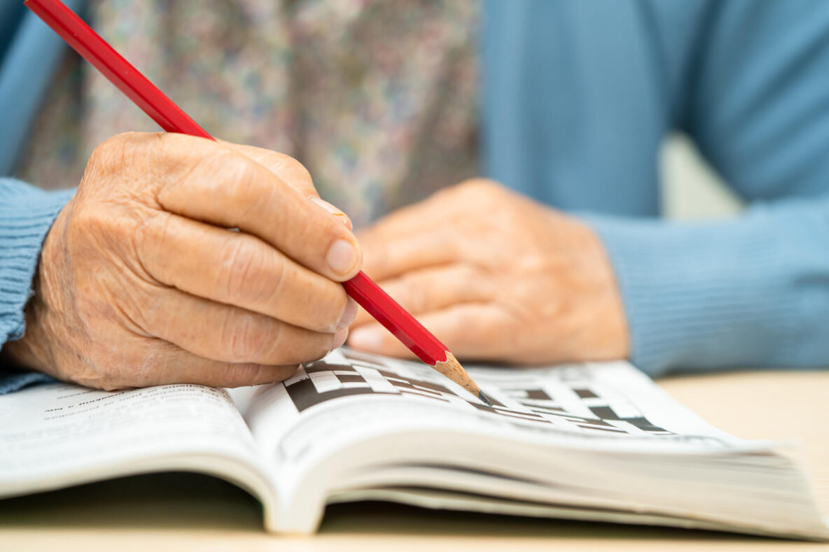 Alzheimer disease AD, Asian elderly woman playing sudoku puzzle