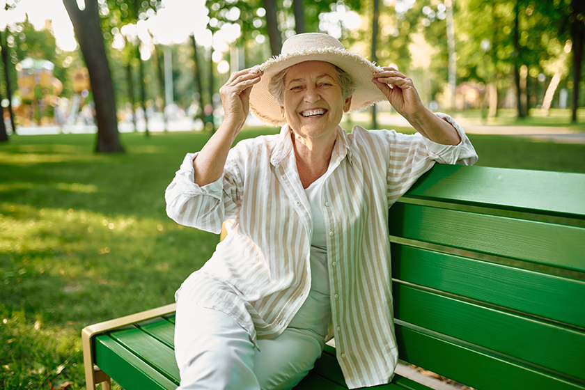 granny in hat sitting on the bench