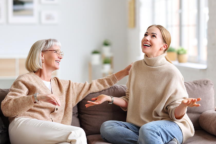 happy adult female laughing sharing funny story smiling mother