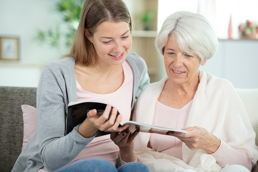 young beautiful smiling woman sitting couch her mother