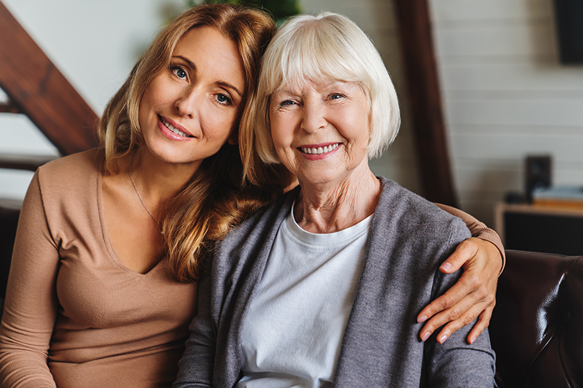 close portrait elderly mother middle aged daughter smiling