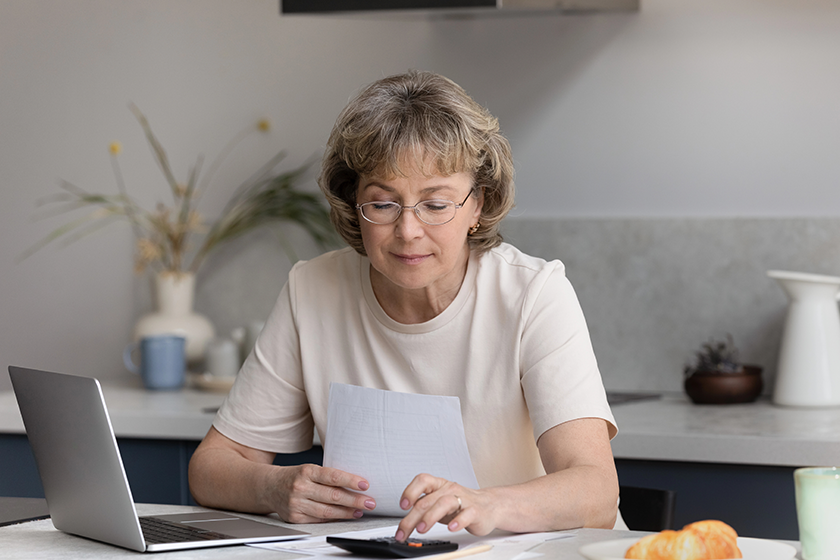 focused middle aged woman calculating bills