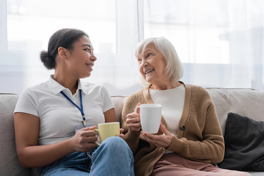 happy multiracial social worker having tea