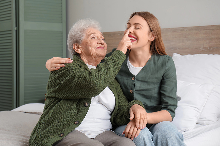 senior woman touching her granddaughter nose