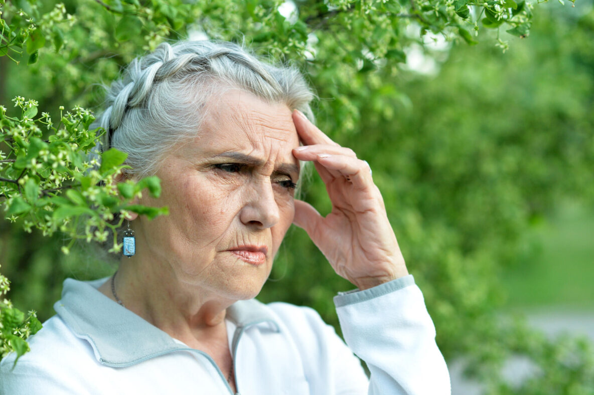 Portrait of senior sad woman in park