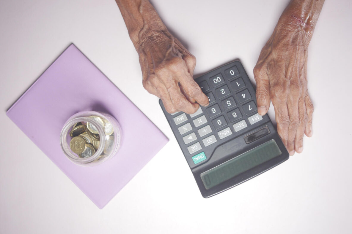 senior women hand using calculator on desk